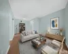 Spacious living area featuring light blue walls and wood-finish flooring Spacious living area featuring light blue walls and wood-finish flooring