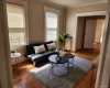 Living room with wood-type flooring and radiator heating unit Living room with wood-type flooring and radiator heating unit