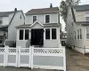 View of front of property featuring a fenced front yard, a chimney, roof with shingles, and a gate View of front of property featuring a fenced front yard, a chimney, roof with shingles, and a gate
