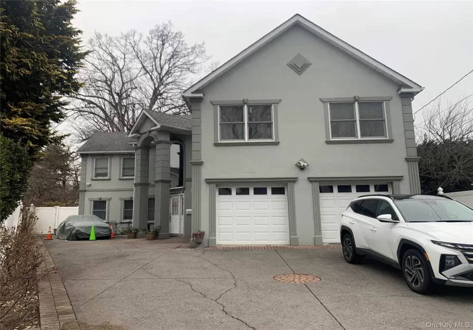 Traditional-style house featuring stucco siding, concrete driveway, an attached garage, and a shingled roof Traditional-style house featuring stucco siding, concrete driveway, an attached garage, and a shingled roof