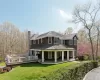 Rear view of property with a chimney, a lawn, and a shingled roof Rear view of property with a chimney, a lawn, and a shingled roof
