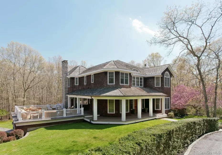 Rear view of property with a chimney, a lawn, and a shingled roof Rear view of property with a chimney, a lawn, and a shingled roof