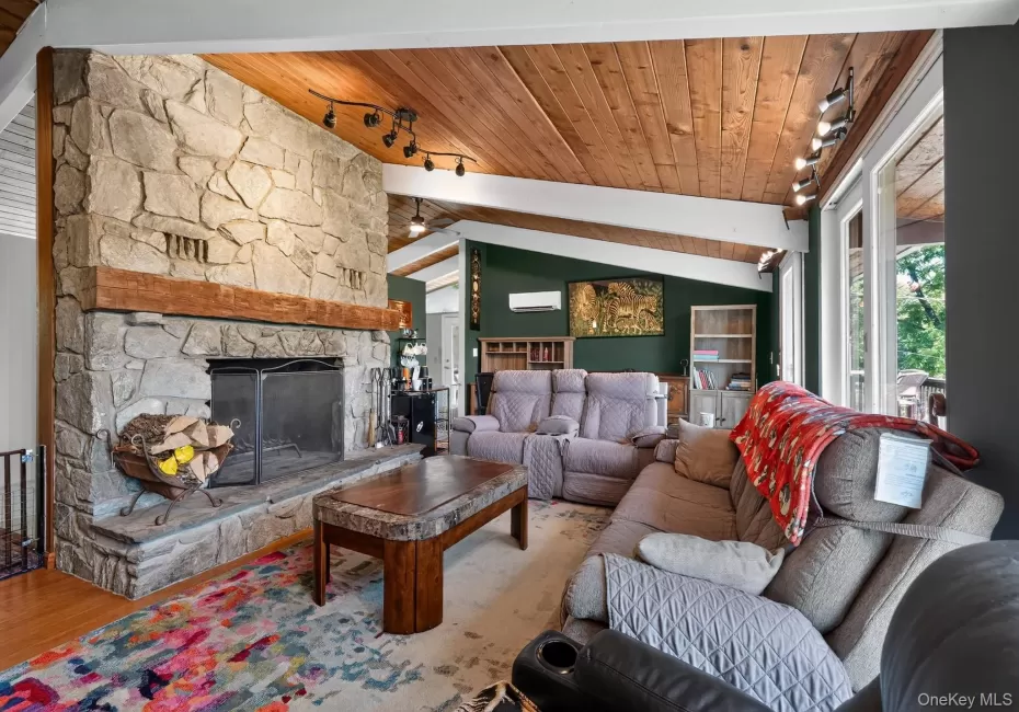Stone fireplace with a substantial timber mantel Stone fireplace with a substantial timber mantel