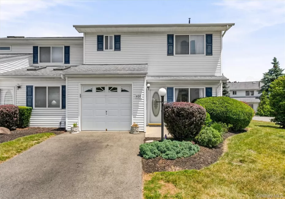 White vinyl siding exterior with dark blue shutters White vinyl siding exterior with dark blue shutters