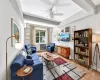 Large and spacious living room with hardwood floors, tall beamed ceilings and large windows with south-western exposure Large and spacious living room with hardwood floors, tall beamed ceilings and large windows with south-western exposure