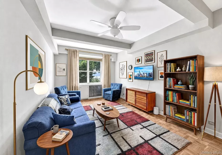 Large and spacious living room with hardwood floors, tall beamed ceilings and large windows with south-western exposure Large and spacious living room with hardwood floors, tall beamed ceilings and large windows with south-western exposure