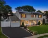 Colonial residence featuring light-colored siding and a contrasting stone facade. AI generated lighting enhanced. Colonial residence featuring light-colored siding and a contrasting stone facade. AI generated lighting enhanced.