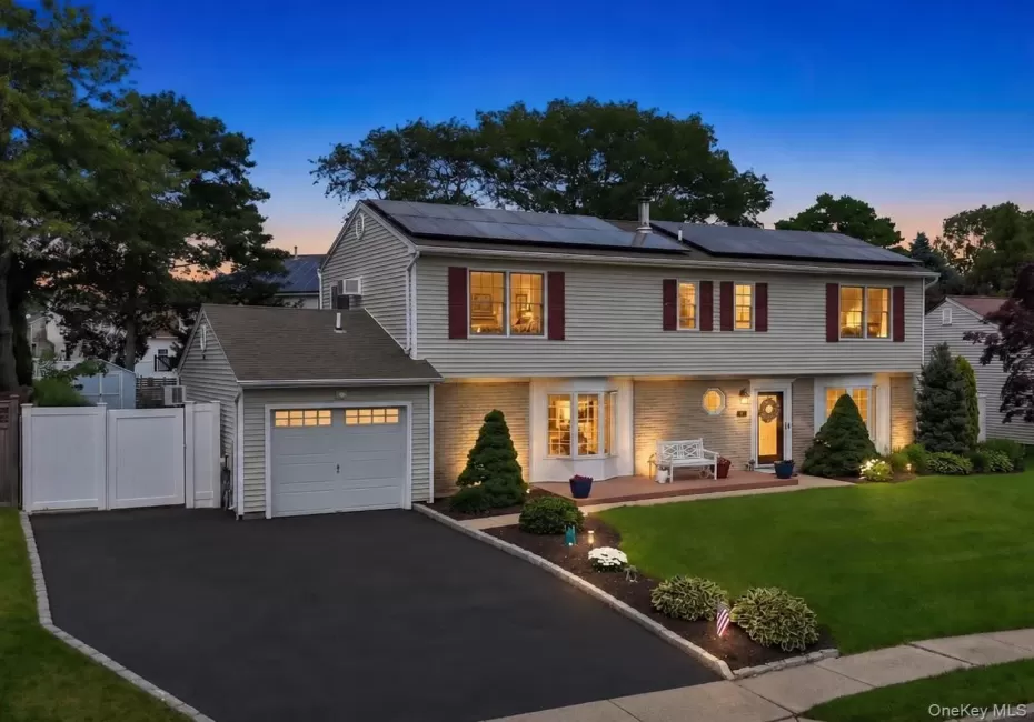 Colonial residence featuring light-colored siding and a contrasting stone facade. AI generated lighting enhanced. Colonial residence featuring light-colored siding and a contrasting stone facade. AI generated lighting enhanced.