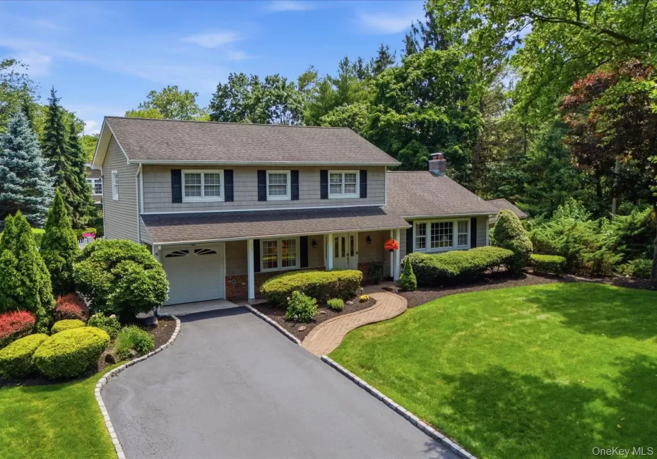 Classic four bedroom colonial with timeless curb appeal, set on a beautifully landscaped property. Classic four bedroom colonial with timeless curb appeal, set on a beautifully landscaped property.