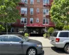 Brick facade building with a prominent red entrance awning Brick facade building with a prominent red entrance awning
