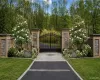 A grand entrance featuring elegant architectural brickwork and impressive 10-foot iron gates creates an immediate sense of luxury and sophistication. A grand entrance featuring elegant architectural brickwork and impressive 10-foot iron gates creates an immediate sense of luxury and sophistication.