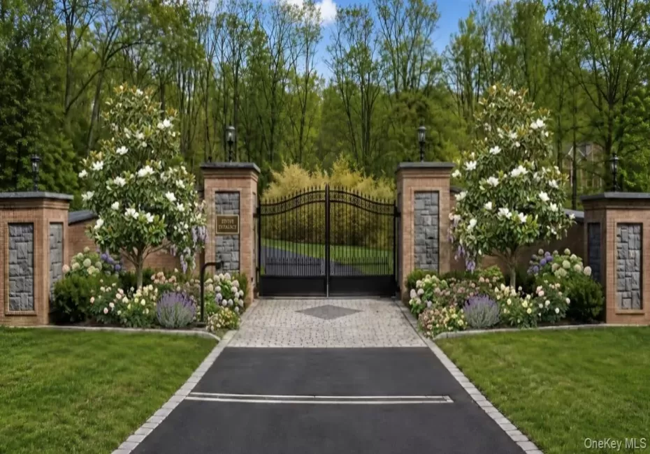 A grand entrance featuring elegant architectural brickwork and impressive 10-foot iron gates creates an immediate sense of luxury and sophistication. A grand entrance featuring elegant architectural brickwork and impressive 10-foot iron gates creates an immediate sense of luxury and sophistication.