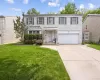 Traditional two-story residence with a light brick facade and dark window shutters Traditional two-story residence with a light brick facade and dark window shutters
