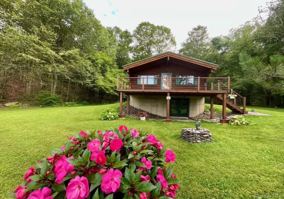 This charming front exterior showcases the 24’ x 34’, Classic Alta Log Home, built in 2005. Featuring classic log cabin architecture, a new "Forest Green" metal roof, deck and driveway improvements, all installed in 2022, are set in a peaceful country setting. This charming front exterior showcases the 24’ x 34’, Classic Alta Log Home, built in 2005. Featuring classic log cabin architecture, a new "Forest Green" metal roof, deck and driveway improvements, all installed in 2022, are set in a peaceful country setting.