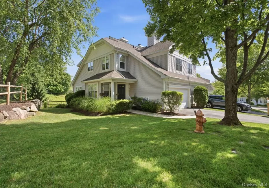 Two-story residence featuring light-colored siding and a multi-level roofline Two-story residence featuring light-colored siding and a multi-level roofline