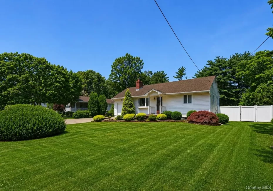 Single-story residence featuring white siding and a brown shingle roof Single-story residence featuring white siding and a brown shingle roof