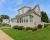 Two-story siding exterior with a front sunroom, a covered porch, and a side entrance Two-story siding exterior with a front sunroom, a covered porch, and a side entrance