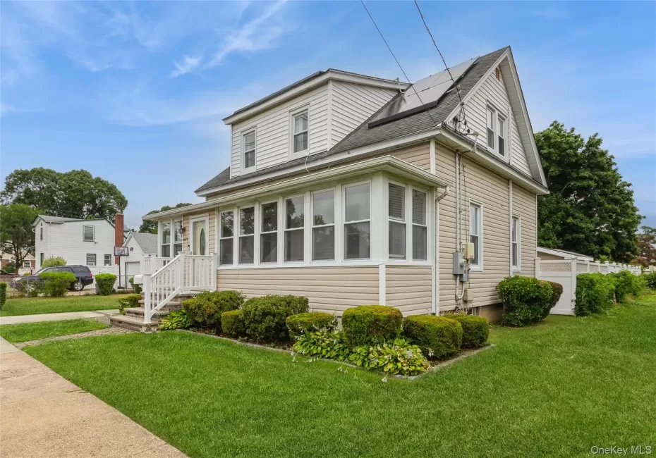 Two-story siding exterior with a front sunroom, a covered porch, and a side entrance Two-story siding exterior with a front sunroom, a covered porch, and a side entrance