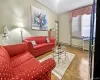 Living room with a baseboard radiator, light parquet flooring, and radiator Living room with a baseboard radiator, light parquet flooring, and radiator