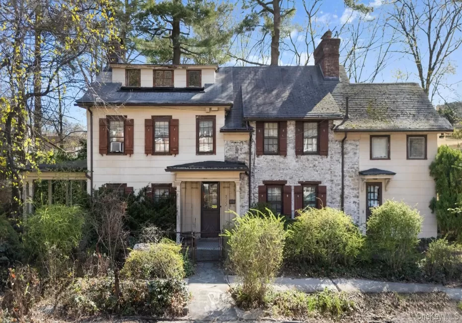 View of front of property with stone siding and a chimney View of front of property with stone siding and a chimney
