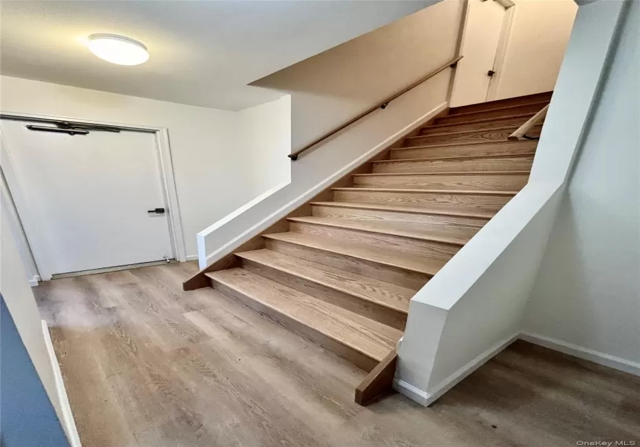 Staircase with wood finished floors and baseboards Staircase with wood finished floors and baseboards
