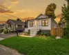 Exterior featuring white horizontal siding with a black horizontal siding accent, black-framed windows, and a white front entry door Exterior featuring white horizontal siding with a black horizontal siding accent, black-framed windows, and a white front entry door