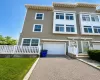 Three-story townhouse with horizontal siding and prominent white trim Three-story townhouse with horizontal siding and prominent white trim