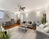 Open and bright living room with high ceilings, refinished hardwood floors (2018), and beautiful crown molding, viewed from entry foyer Open and bright living room with high ceilings, refinished hardwood floors (2018), and beautiful crown molding, viewed from entry foyer