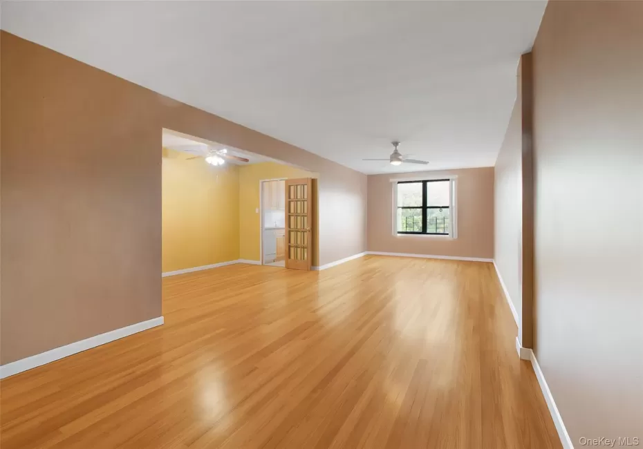 Unfurnished room with light wood-style floors and a ceiling fan Unfurnished room with light wood-style floors and a ceiling fan
