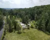 View from above of property with a heavily wooded area View from above of property with a heavily wooded area