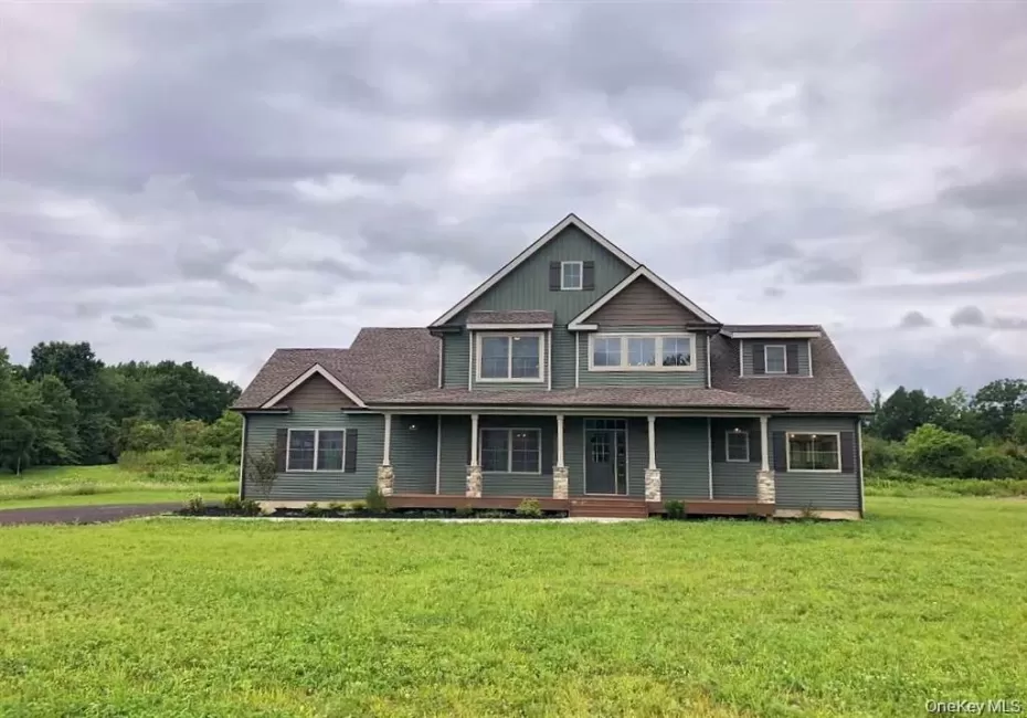 Relax and enjoy the outdoors from the covered porch, offering a comfortable space to unwind in every season. Relax and enjoy the outdoors from the covered porch, offering a comfortable space to unwind in every season.