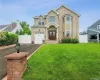View of front of home featuring brick siding, asphalt driveway, an attached garage, and french doors View of front of home featuring brick siding, asphalt driveway, an attached garage, and french doors