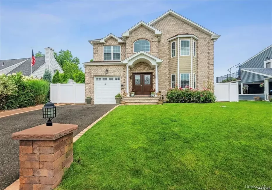 View of front of home featuring brick siding, asphalt driveway, an attached garage, and french doors View of front of home featuring brick siding, asphalt driveway, an attached garage, and french doors
