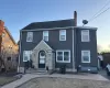 The property features a dark gray exterior with white trim and a stone facade entryway The property features a dark gray exterior with white trim and a stone facade entryway