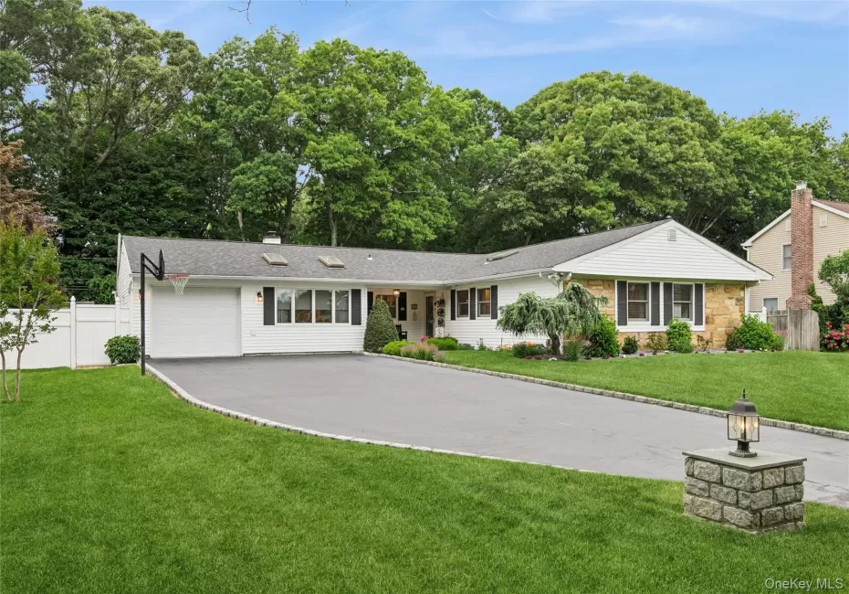 Contemporary ranch-style residence featuring a combination of white siding and stone facade Contemporary ranch-style residence featuring a combination of white siding and stone facade
