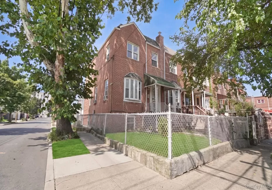 Brick exterior with a prominent bay window, covered front porch, and a fenced front yard Brick exterior with a prominent bay window, covered front porch, and a fenced front yard