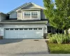 View of front facade with driveway, stone siding, a garage, and roof with shingles View of front facade with driveway, stone siding, a garage, and roof with shingles
