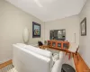 Living area featuring wood-finish flooring, light-toned walls, and white baseboards Living area featuring wood-finish flooring, light-toned walls, and white baseboards