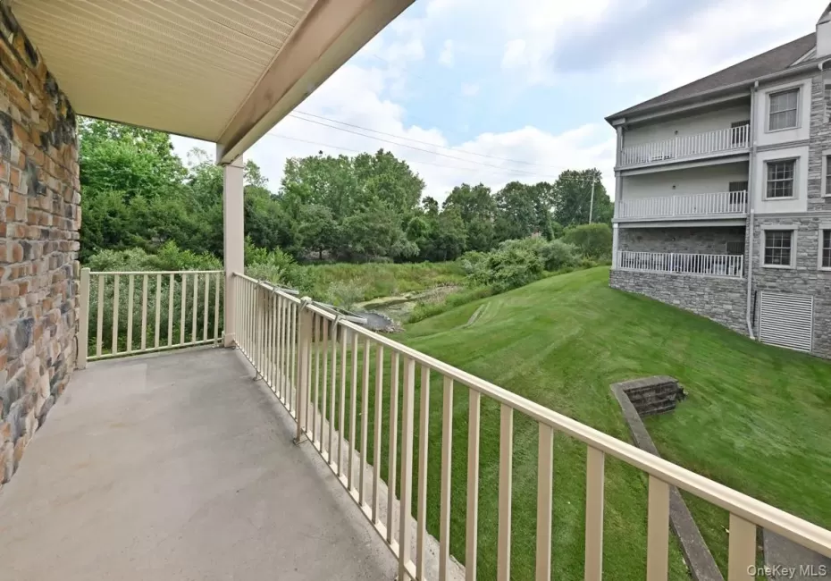 Extra large balcony with beautiful view of landscaping and pond with waterfall. Extra large balcony with beautiful view of landscaping and pond with waterfall.