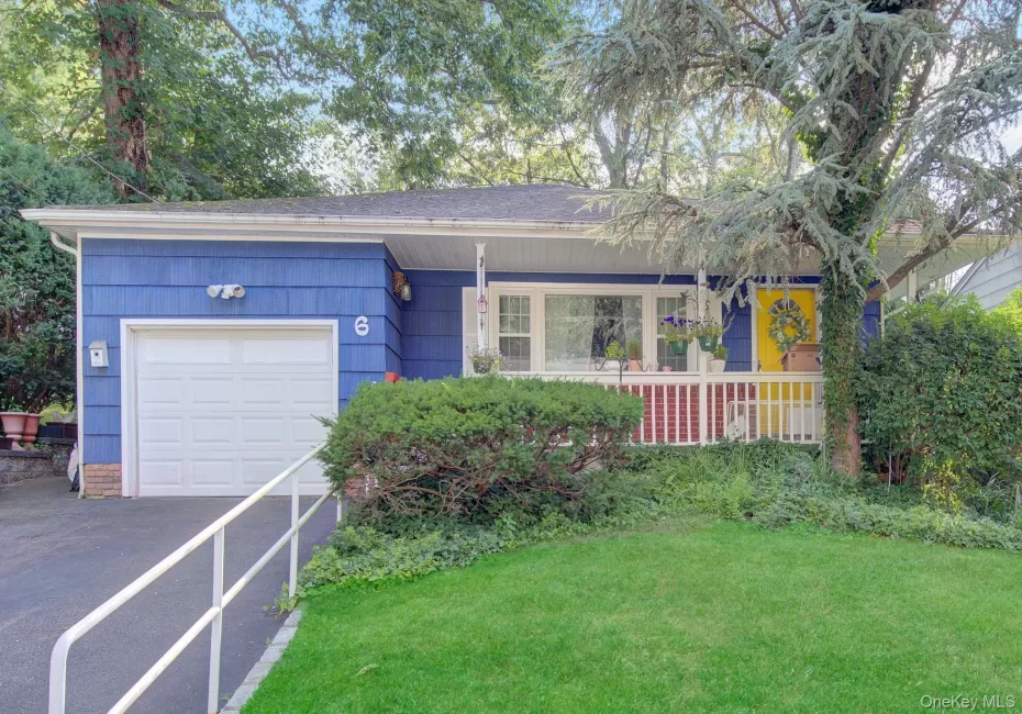 Blue siding exterior with a white garage door Blue siding exterior with a white garage door