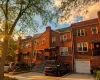 Brick facade residence featuring multiple windows, a front porch with an awning, and a private driveway Brick facade residence featuring multiple windows, a front porch with an awning, and a private driveway