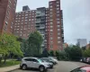 View of apartment building / complex with uncovered parking View of apartment building / complex with uncovered parking