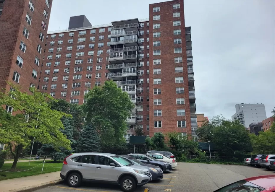 View of apartment building / complex with uncovered parking View of apartment building / complex with uncovered parking