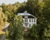 Back of property featuring a wooded view Back of property featuring a wooded view