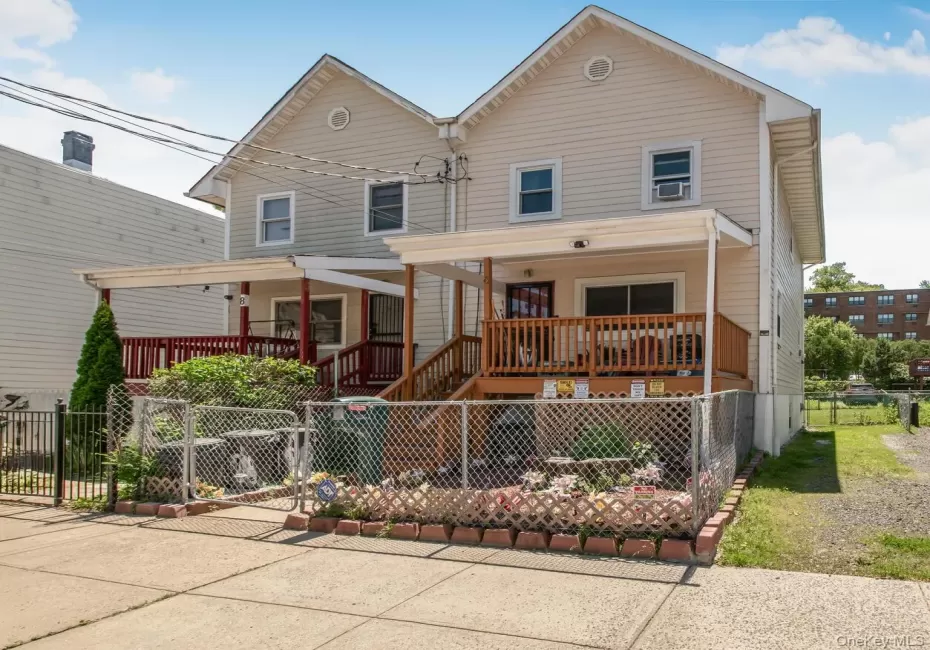 Traditional-style house featuring covered porch and stairway Traditional-style house featuring covered porch and stairway