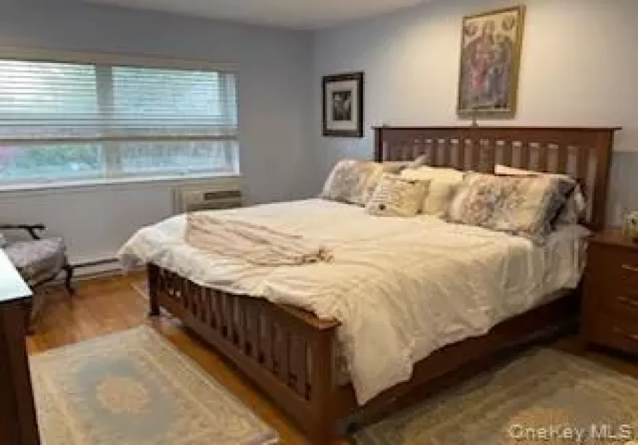 Hardwood flooring complemented by a A/C window unit and baseboard heating Hardwood flooring complemented by a A/C window unit and baseboard heating