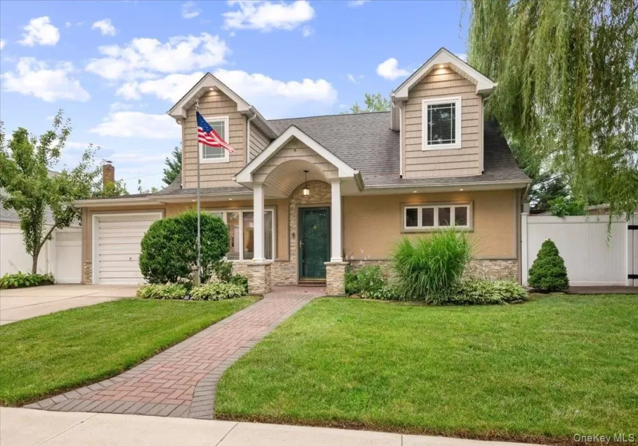 Beautifully Updated and Expanded Cape with Oversized Portico, Stone, Stucco, Vinyl Siding and newer architectural shingle roof. Beautifully Updated and Expanded Cape with Oversized Portico, Stone, Stucco, Vinyl Siding and newer architectural shingle roof.