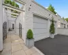 Two-car garage and entry to 32 Beechwood through iron gate. Two-car garage and entry to 32 Beechwood through iron gate.