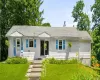 Charming home featuring a welcoming front porch and a beautifully landscaped yard. Charming home featuring a welcoming front porch and a beautifully landscaped yard.