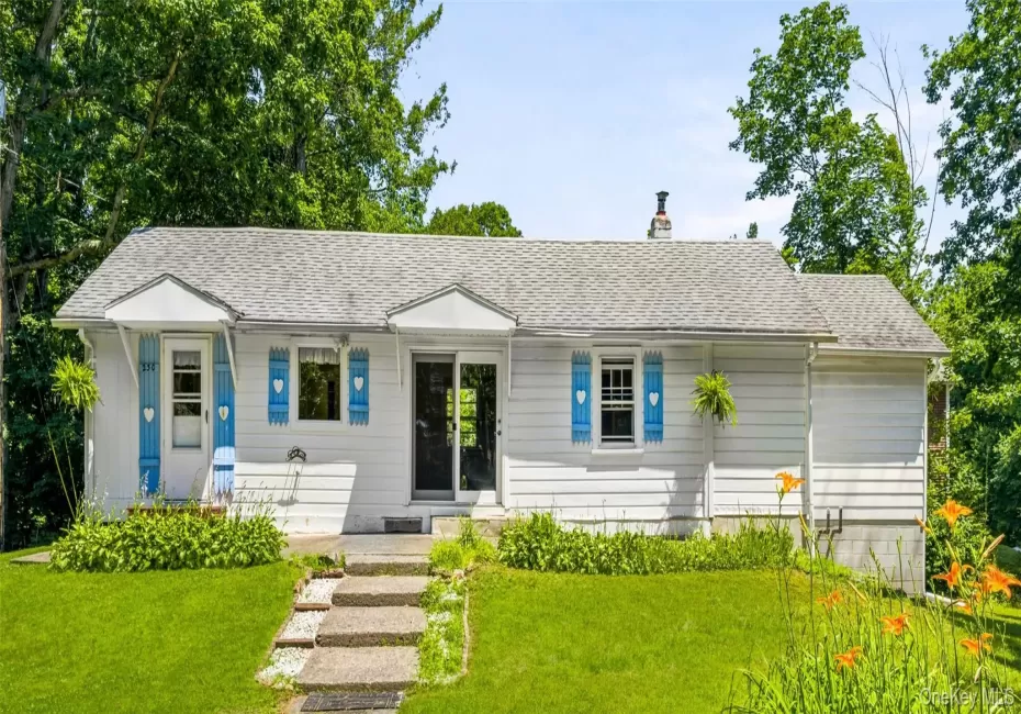 Charming home featuring a welcoming front porch and a beautifully landscaped yard. Charming home featuring a welcoming front porch and a beautifully landscaped yard.